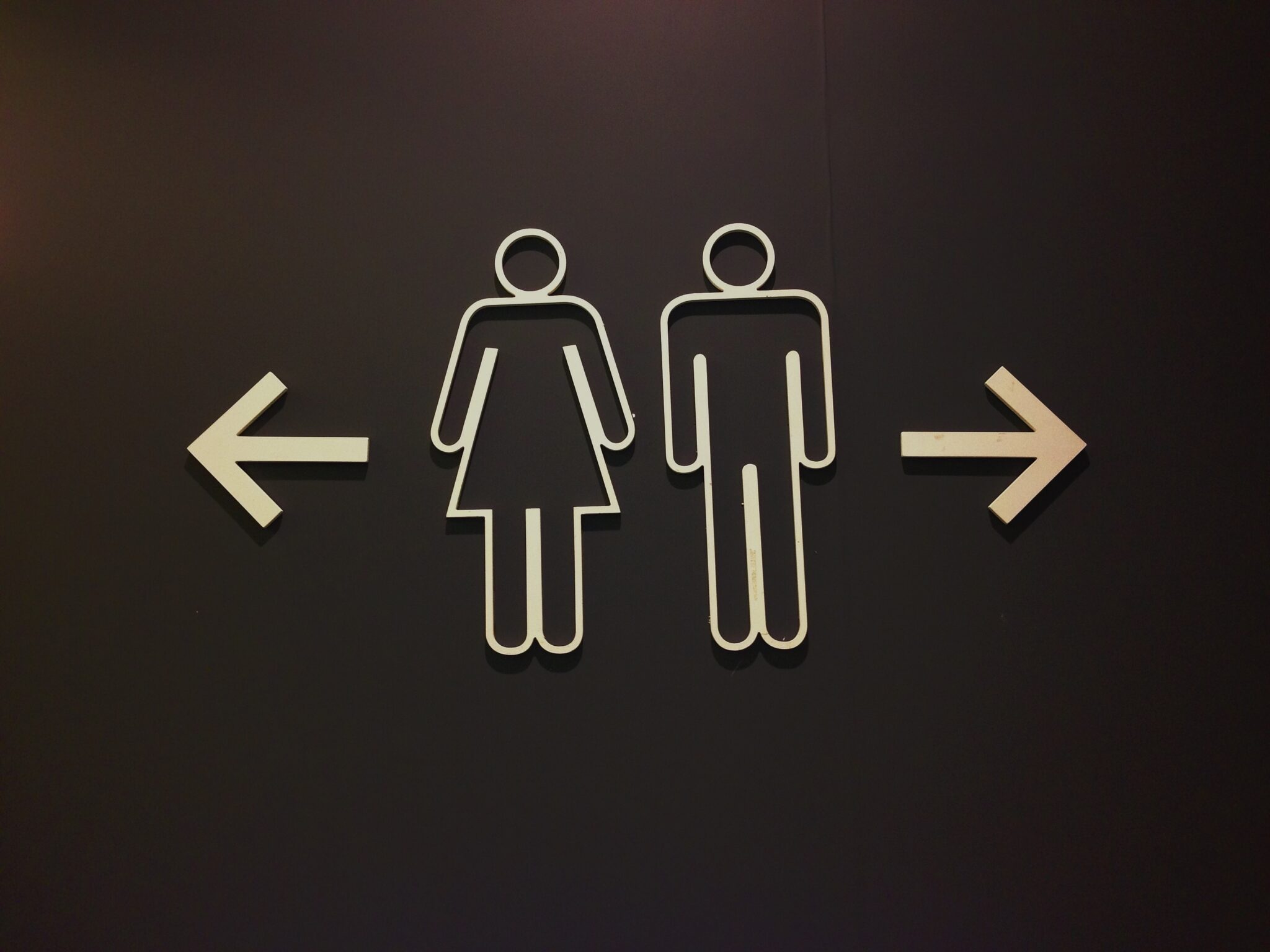 Sign of public restroom on black background